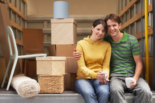 Movers assembling furniture in a new home